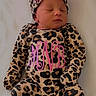 Maci is registered to the contest to win money with this photo: newborn, baby, sleeping, leopard_print, onesie, hat, pink_bow, infant, cute, lying_down, soft_surface, child, portrait, adorable, peaceful, monogram, clothing, headwear, small, resting