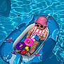 baby, inflatable_boat, pool, water, sunhat, sunglasses, toy, pink, blue, dolphin_design, summer, child, float, swimming, outdoor, play, cute, relax, sunshine, fun