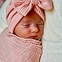 baby, blanket, calm, closed_eyes, closeup, cozy, face, headwear, home, infant, knit_hat, newborn, peaceful, pink_bow, portrait, sleeping, soft_texture, studio_style, swaddled, wrapped