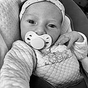 Lou participe au concours pour gagner de l'argent avec cette photo : baby, black_and_white, blanket, bow, buckle, car_seat, close_up, clothing, cozy, eyes, hand, headband, infant, newborn, onesie, pacifier, portrait, quilted, seat, skin
