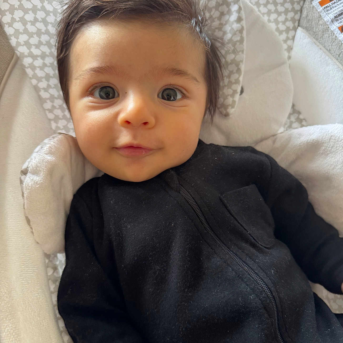 Davi joined the competition — help win amazing prizes! baby, baby_seat, black_clothing, child, closeup, cozy, cushion, cute, expression, eyes, face, head, indoor, infant, patterned_background, person, portrait, smile, soft_lighting, young_child