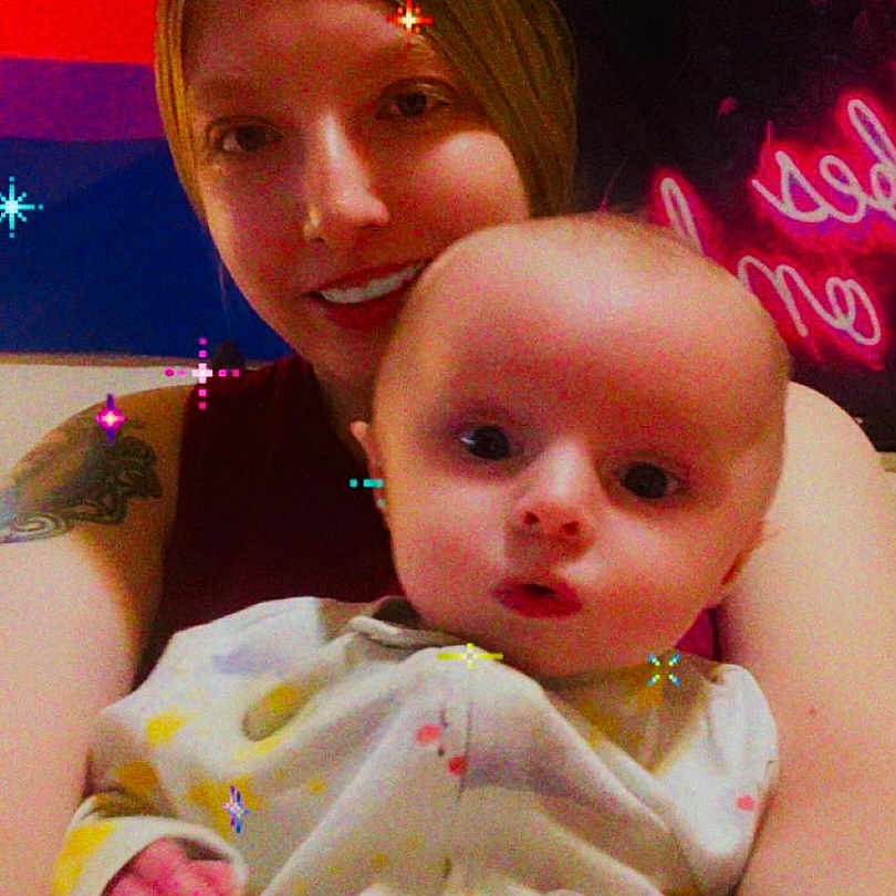 Braxton joined the competition — help win amazing prizes! baby, child, closeup, colorful, cute, expression, face, happy, head, holding, indoor, onesie, person, portrait, selfie, skin, smiling, sparkles, woman, young