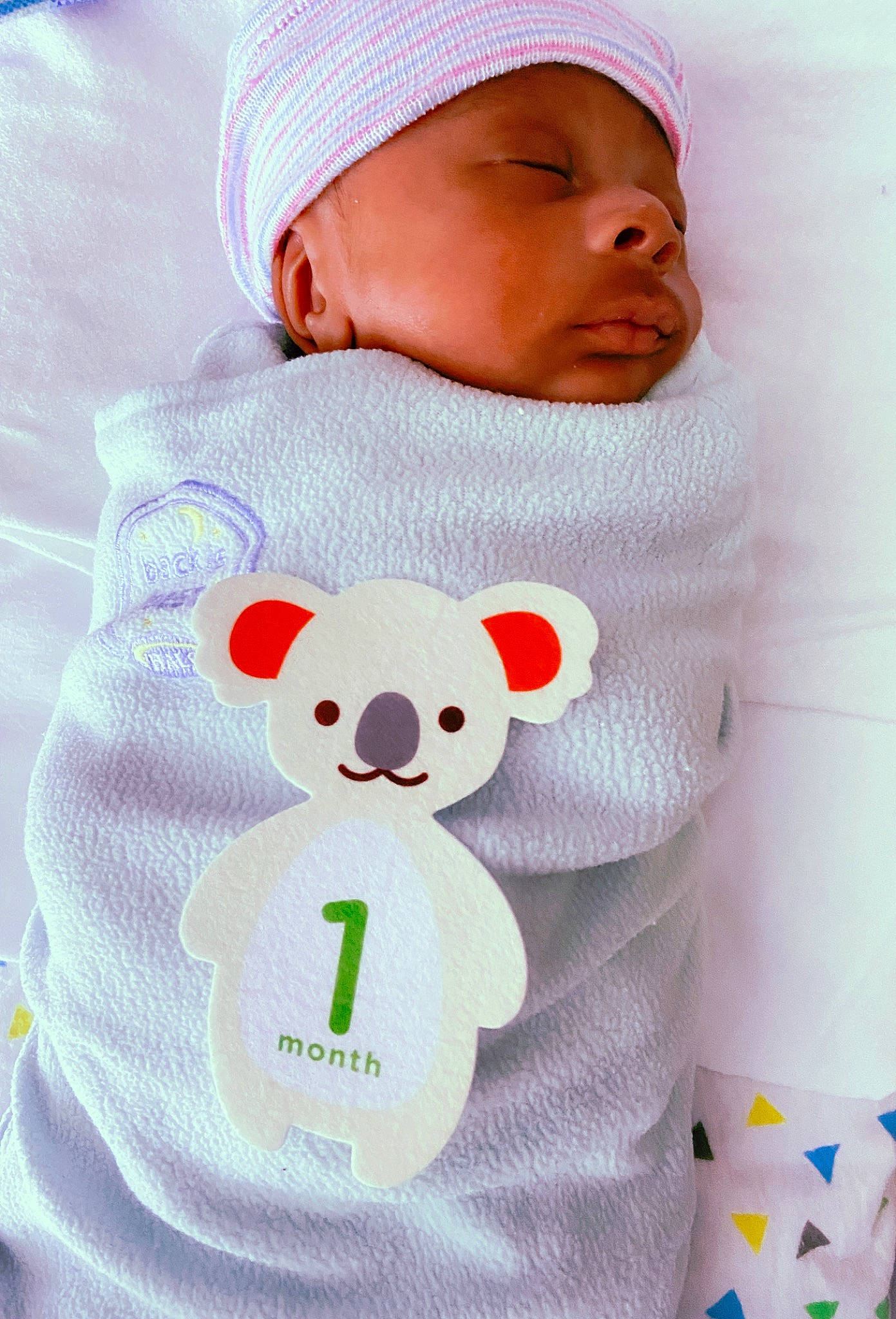 Prince is registered to the contest to win money with this photo: baby, baby_products, baby_safety, baby_sleeping, baby_toddler_clothing, child, comfort, green, hat, head, linens, outerwear, pattern, person, pink, sleeve, t_shirt, textile, toddler, toy
