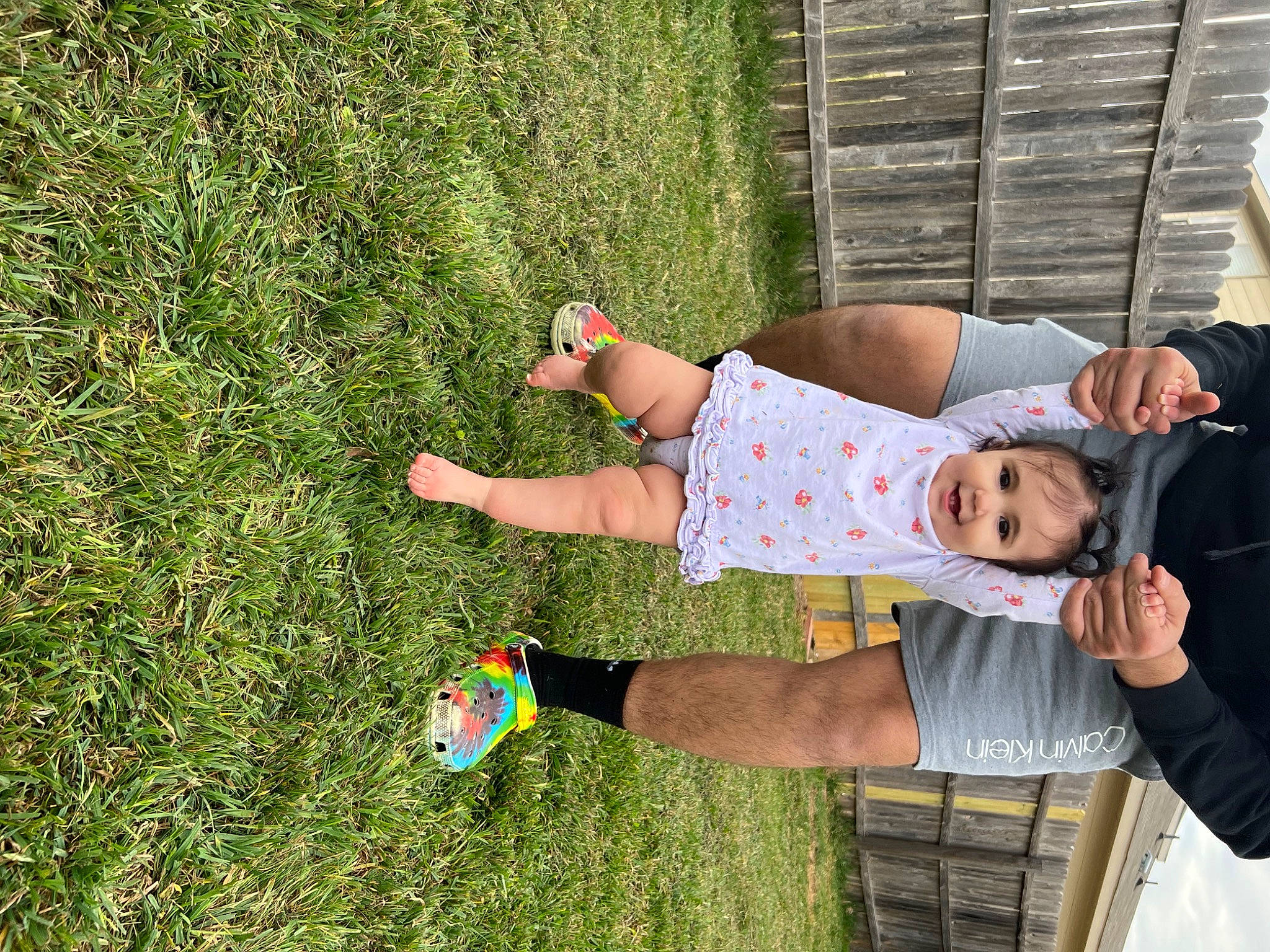 Valentina is registered to the contest to win money with this photo: arm, ball, child, elbow, fun, grass, grass_family, grassland, green, happy, hat, human_leg, joy, lawn, leisure, people_in_nature, person, recreation, shorts, sitting