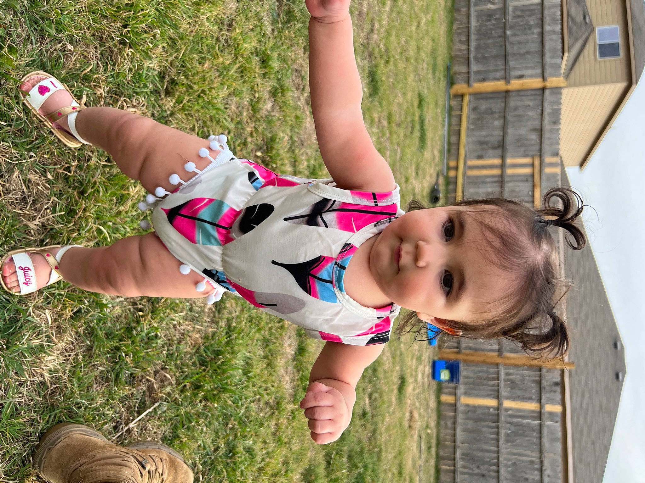 Valentina is registered to the contest to win money with this photo: footwear, fun, grass, happy, human_leg, knee, leg, leisure, people_in_nature, person, photograph, plant, recreation, sandal, shoe, sneakers, thigh, toddler, tree, trunk