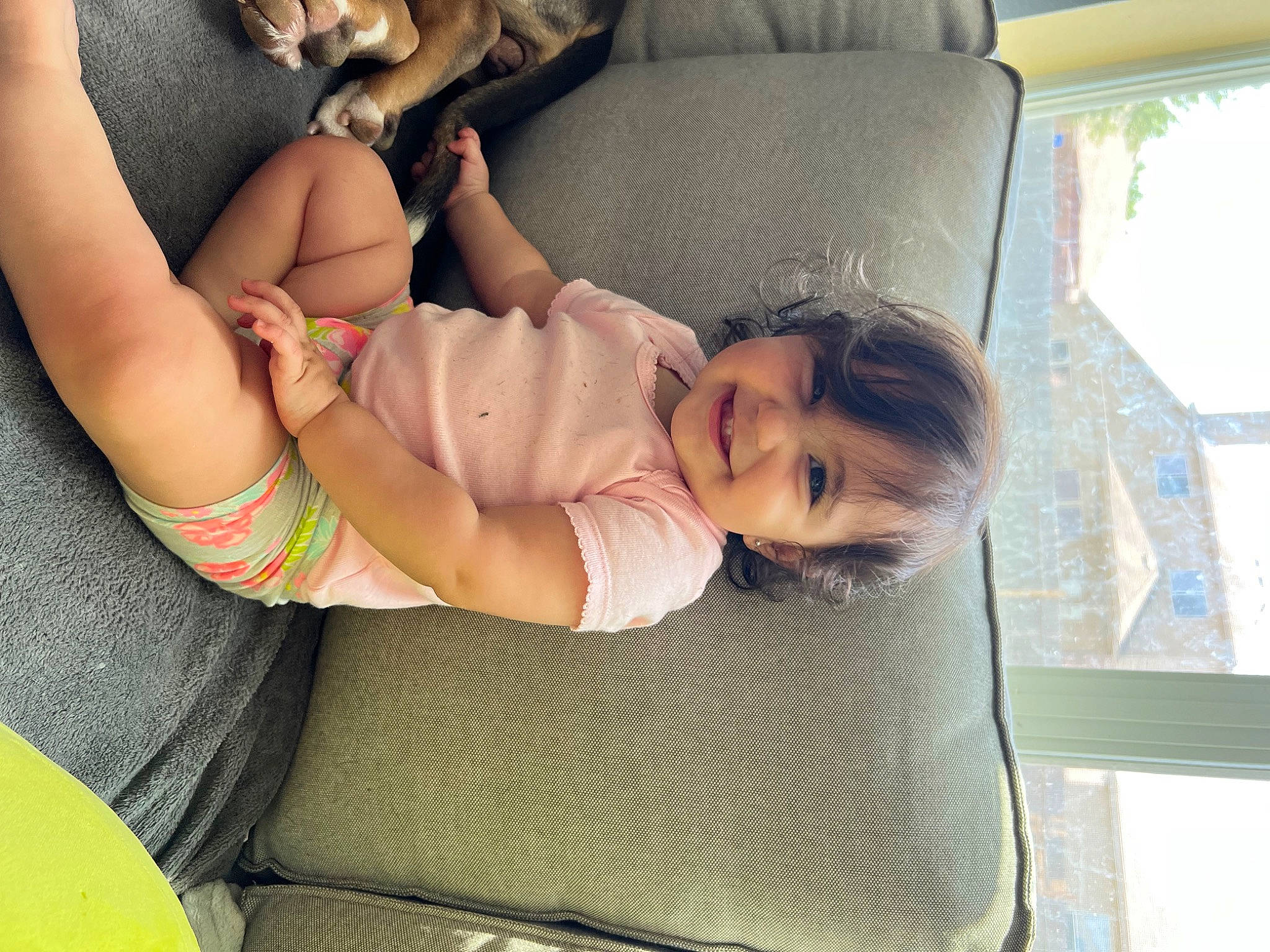 Valentina is registered to the contest to win money with this photo: arm, baby, car_seat, comfort, elbow, finger, fun, grass, hand, happy, human_body, joy, knee, leg, leisure, mammal, mouth, person, skin, thigh