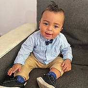 Djarown participe au concours pour gagner de l'argent avec cette photo : toddler, child, boy, smiling, sitting, couch, shoe, clothing, blue_socks, beige_pants, striped_shirt, bow_tie, hair, indoor, furniture, happy, person, portrait, casual, cute