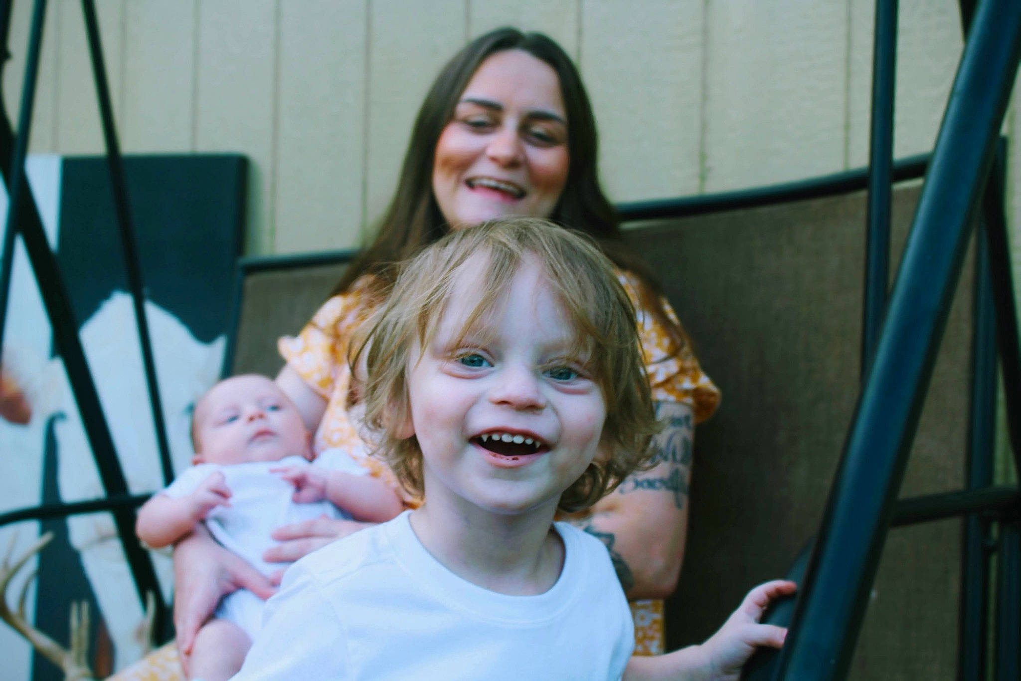 Jacob is registered to the contest to win money with this photo: baby, blond, chair, child, community, event, face, facial_expression, fun, gesture, happy, joy, laugh, leisure, person, recreation, skin, smile, swing, t_shirt