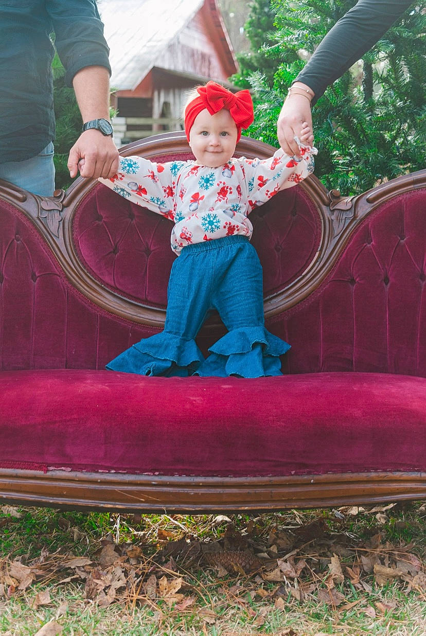 Hayden is registered to the contest to win money with this photo: baby_toddler_clothing, child, chute, fun, grass, green, headwear, joy, leisure, magenta, outdoor_play_equipment, person, pink, plant, playground, playground_slide, purple, recreation, red, smile