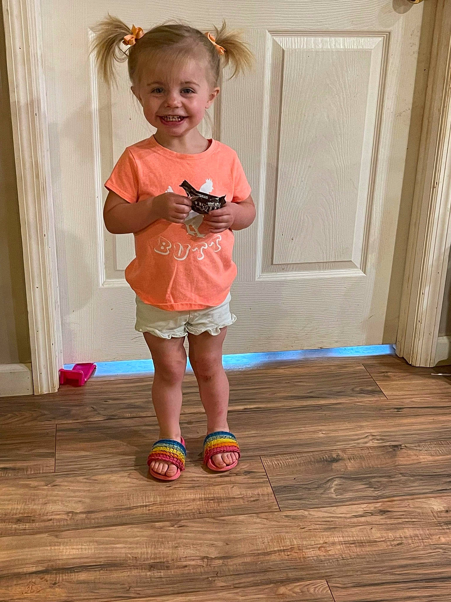 Charleigh joined the competition — help win amazing prizes! baby_toddler_clothing, child, door, floor, flooring, happy, hardwood, joy, laminate_flooring, leg, pattern, person, pink, plank, shoe, sleeve, smile, standing, toddler, varnish
