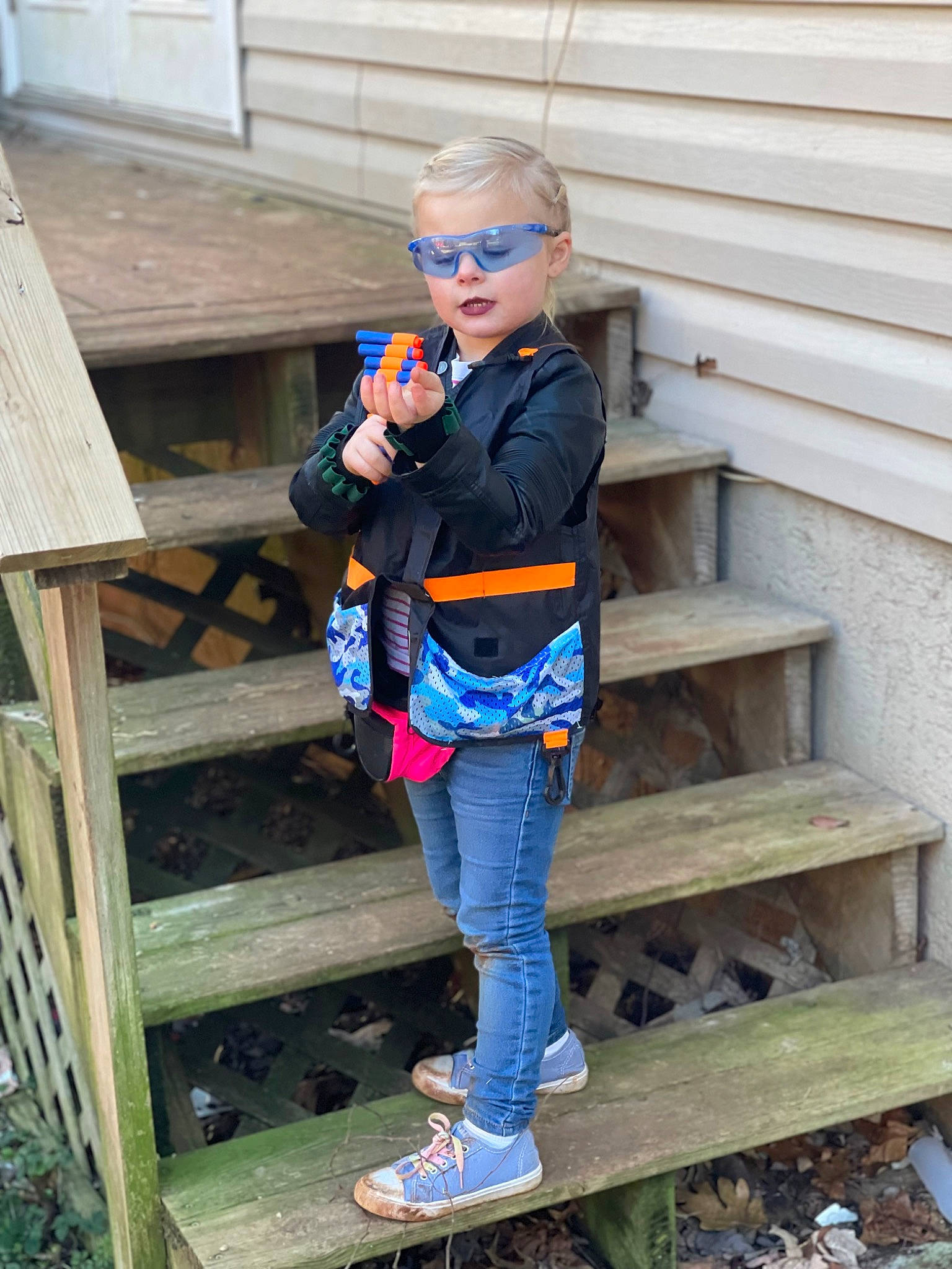 Kymberlin is registered to the contest to win money with this photo: boot, child, denim, electric_blue, eyewear, glasses, grass, jeans, leisure, pattern, person, shoe, sitting, sneakers, standing, street_fashion, sunglasses, t_shirt, thigh, waist