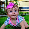baby, blue_eyes, child, crawling, cute, dimples, fence, grass, greenery, headband, infant, outdoor, patterned_clothing, person, pink_bow, portrait, short_sleeve, smiling, sunlight, yard