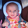 baby, child, car_seat, smiling, pacifier, floral_dress, straps, cushion, plush_toy, happy, infant, portrait, closeup, person, cute, indoors, seatbelt, head_support, bright, colorful
