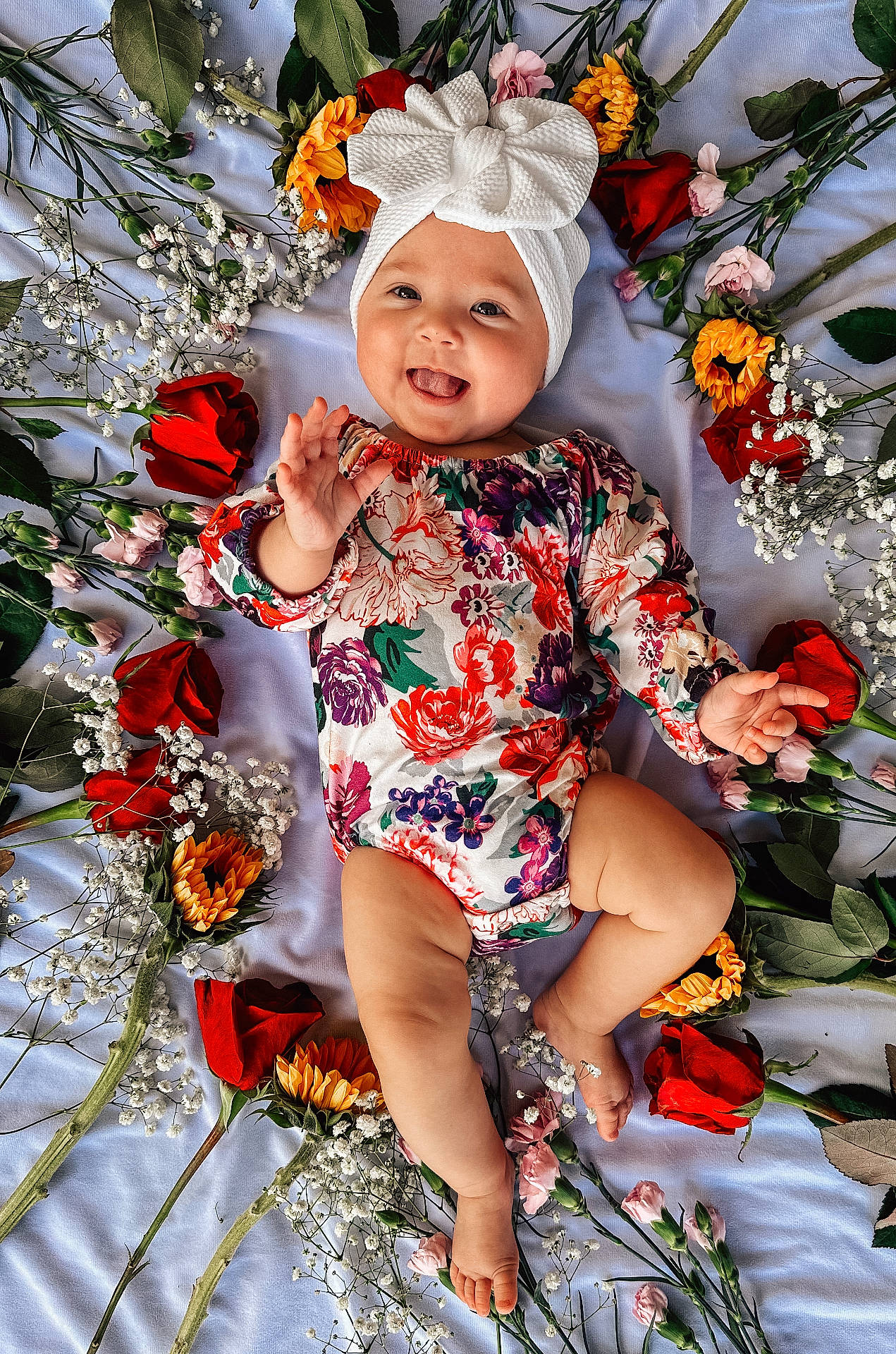 Tilly is registered to the contest to win money with this photo: baby, bodypart, bonnet, cap, clothing, dress, face, finger, flower, flowerarrangement, flowerbouquet, hand, hat, head, person, petal, photography, plant, portrait, rose