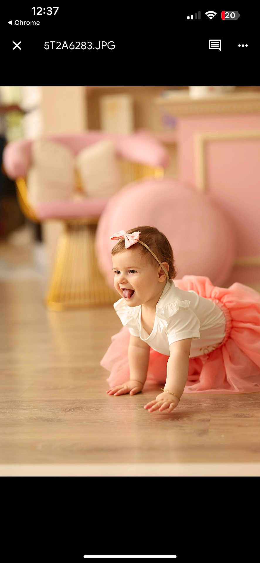 Daisy Bejkollari joined the competition — help win amazing prizes! baby, child, tutu, pink, crawling, tongue_out, headband, indoor, wooden_floor, smiling, cute, playful, girl, furniture, chair, cushions, soft_lighting, portrait, happy, home