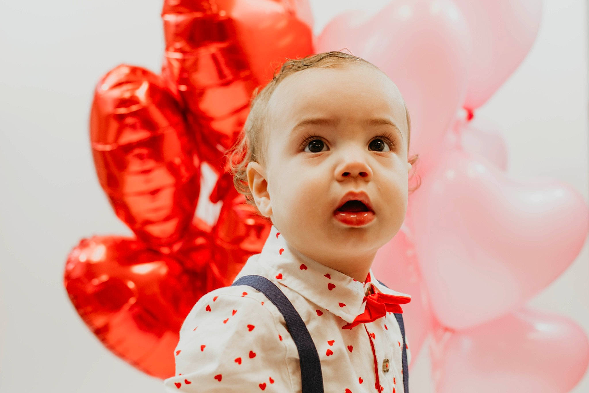 Kohen is registered to the contest to win money with this photo: art, baby, baby_toddler_clothing, carmine, child, collar, event, fictional_character, fun, gesture, happy, party_supply, peach, performing_arts, person, pink, red, sleeve, smile, surprise