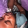 baby, sleeping, plush_toy, purple, blanket, infant, child, peaceful, closeup, hand, soft_texture, cozy, eyelashes, skin, cute, resting, indoors, bed, comfort, nap