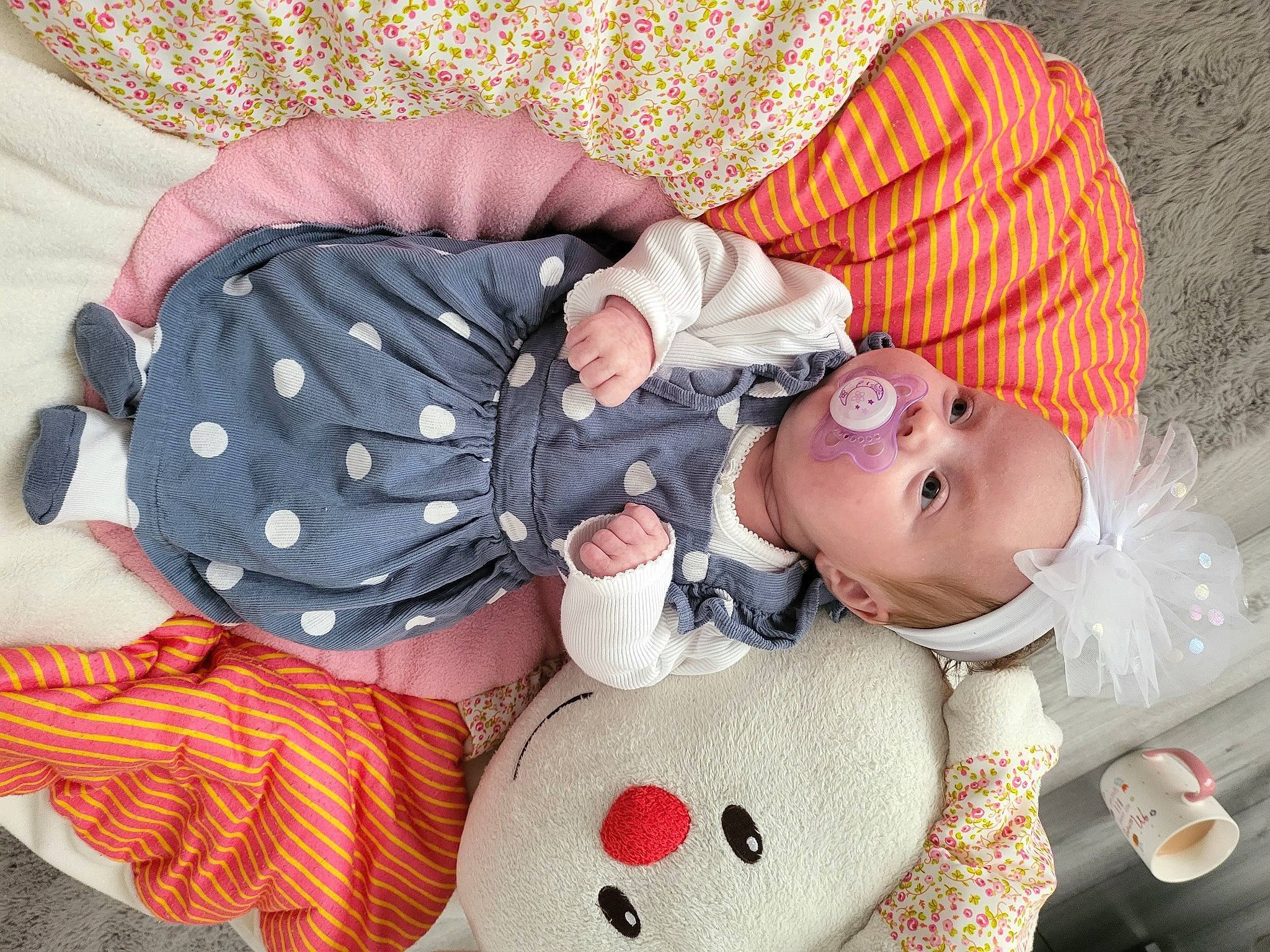 Lily-rose is registered to the contest to win money with this photo: baby, baby_products, baby_sleeping, baby_toddler_clothing, carmine, cheek, child, comfort, lap, linens, mouth, pattern, person, pink, product, red, sitting, skin, sleeve, textile