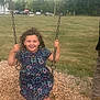 Haley joined the competition — help win amazing prizes! child, girl, swing, playground, smile, happy, outdoor, grass, trees, woodchips, dress, curly_hair, park, daytime, person, fun, holding, chain, casual_clothing, recreation
