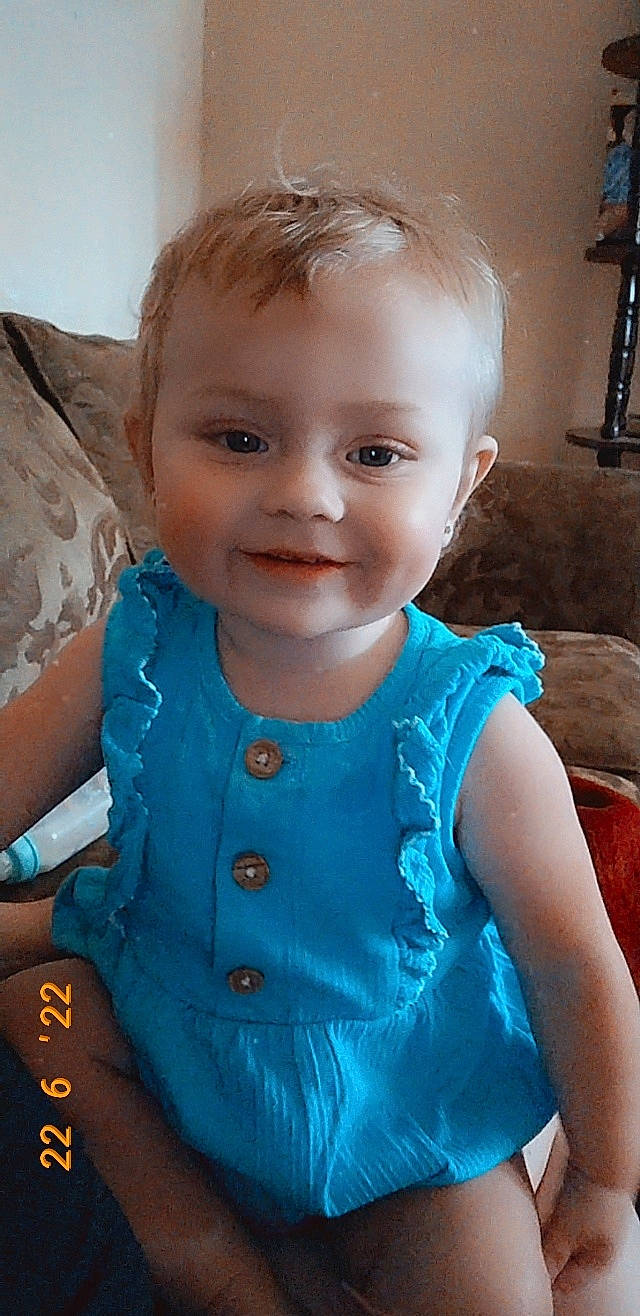 Annalynn is registered to the contest to win money with this photo: azure, baby_toddler_clothing, cheek, dress, eye, face, facial_expression, finger, gesture, hair, happy, head, iris, joy, lip, mouth, neck, nose, person, shoulder