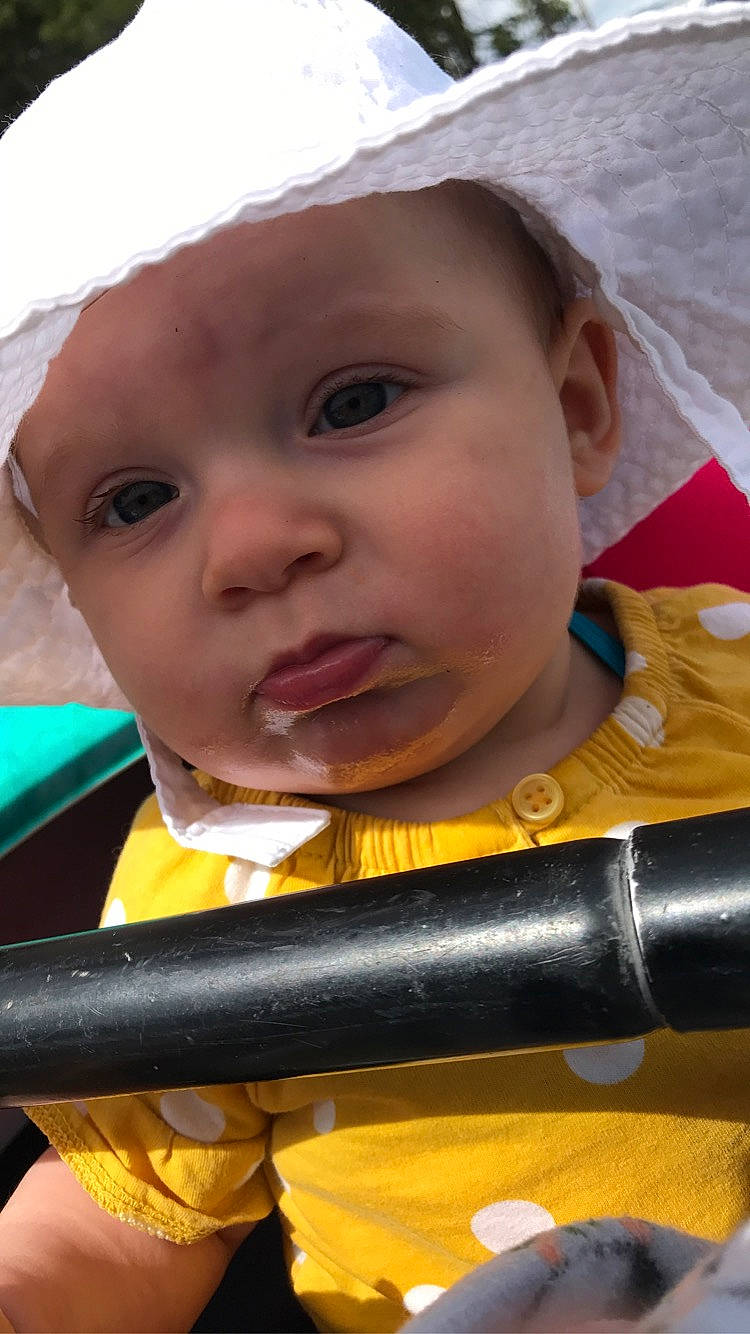 Rylie is registered to the contest to win money with this photo: baby, baby_products, cheek, child, chin, close_up, eye, eyebrow, eyelash, fashion_accessory, fun, happy, hat, iris, lip, nose, organ, person, skin, toddler