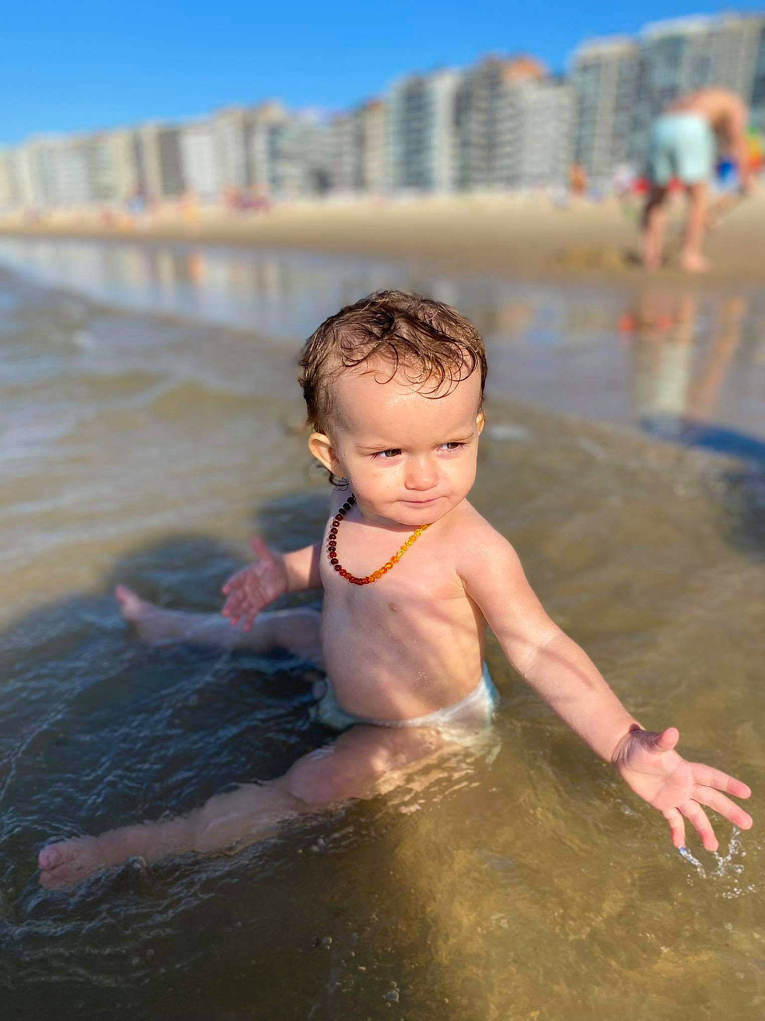 Tyana a rejoint le concours — aidez-le/la à gagner de superbes lots ! barechested, bathing, beach, body_of_water, chest, child, fun, happy, leisure, ocean, people_on_beach, person, recreation, sand, sky, sunlight, toddler, vacation, water, wave