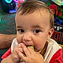 toddler, child, face, hand, food, eating, vegetable, cucumber, curious, indoors, arcade, colorful, closeup, cute, baby, playful, casual, person, skin, hair
