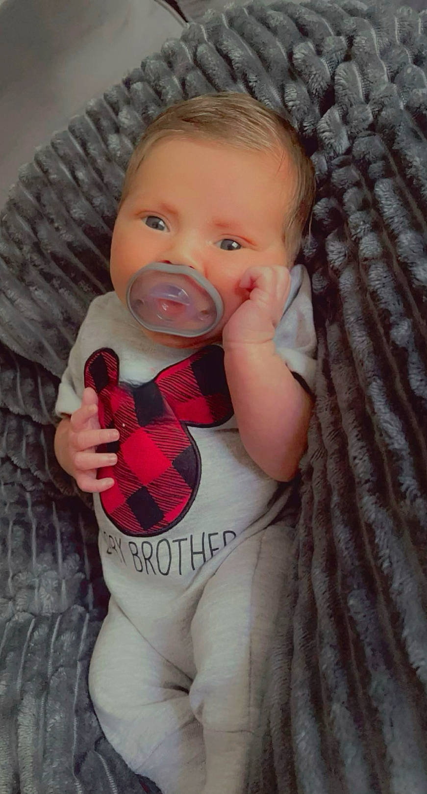 Chozen is registered to the contest to win money with this photo: baby, baby_products, baby_toddler_clothing, cheek, child, comfort, eye, face, hand, head, iris, lip, outerwear, pattern, person, pink, sitting, skin, sleeve, textile