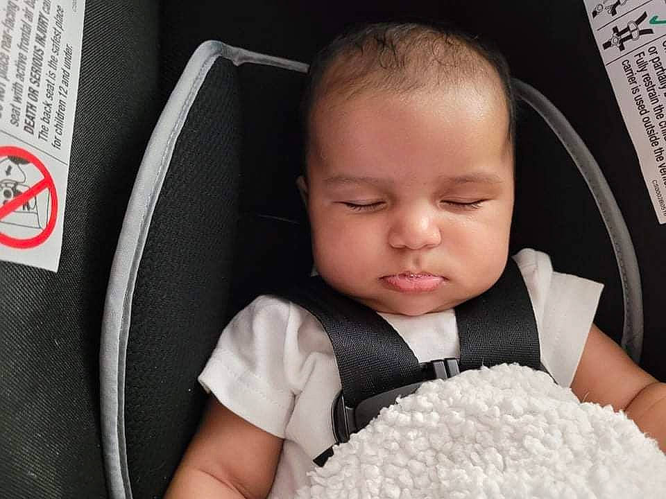 Kahlani is registered to the contest to win money with this photo: baby, baby_sleeping, baby_toddler_clothing, black, car_seat, cheek, child, comfort, eyelash, facial_expression, hairstyle, happy, human, nose, pattern, person, seat_belt, sitting, skin, sleeve