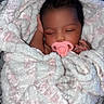 Harlo is registered to the contest to win money with this photo: baby, newborn, pacifier, blanket, sleeping, infant, wrapped, soft_texture, cute, child, resting, cozy, face, hand, indoors, peaceful, portrait, warm, toddler, comfort