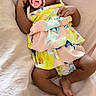 Harlo is registered to the contest to win money with this photo: baby, infant, pacifier, blanket, floral_dress, cute, lying_down, soft_texture, skin, hands, feet, newborn, child, adorable, portrait, indoors, comfort, resting, colorful_clothing, peaceful