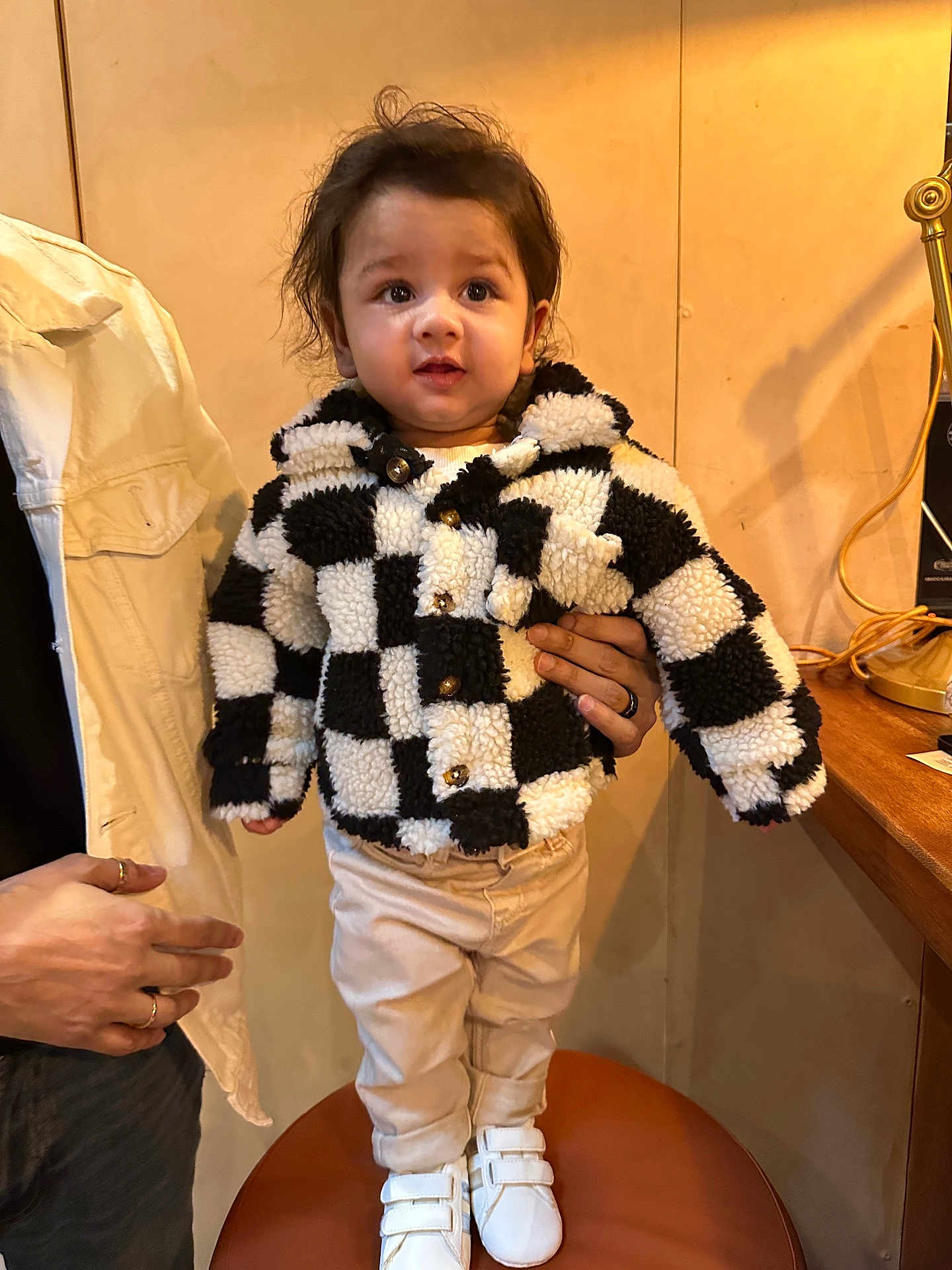 Arkay joined the competition — help win amazing prizes! toddler, child, jacket, checkered_pattern, white_shoes, standing, indoor, person, hand, support, pants, brown_hair, cute, warm_lighting, chair, casual, background, smiling, fashion, portrait