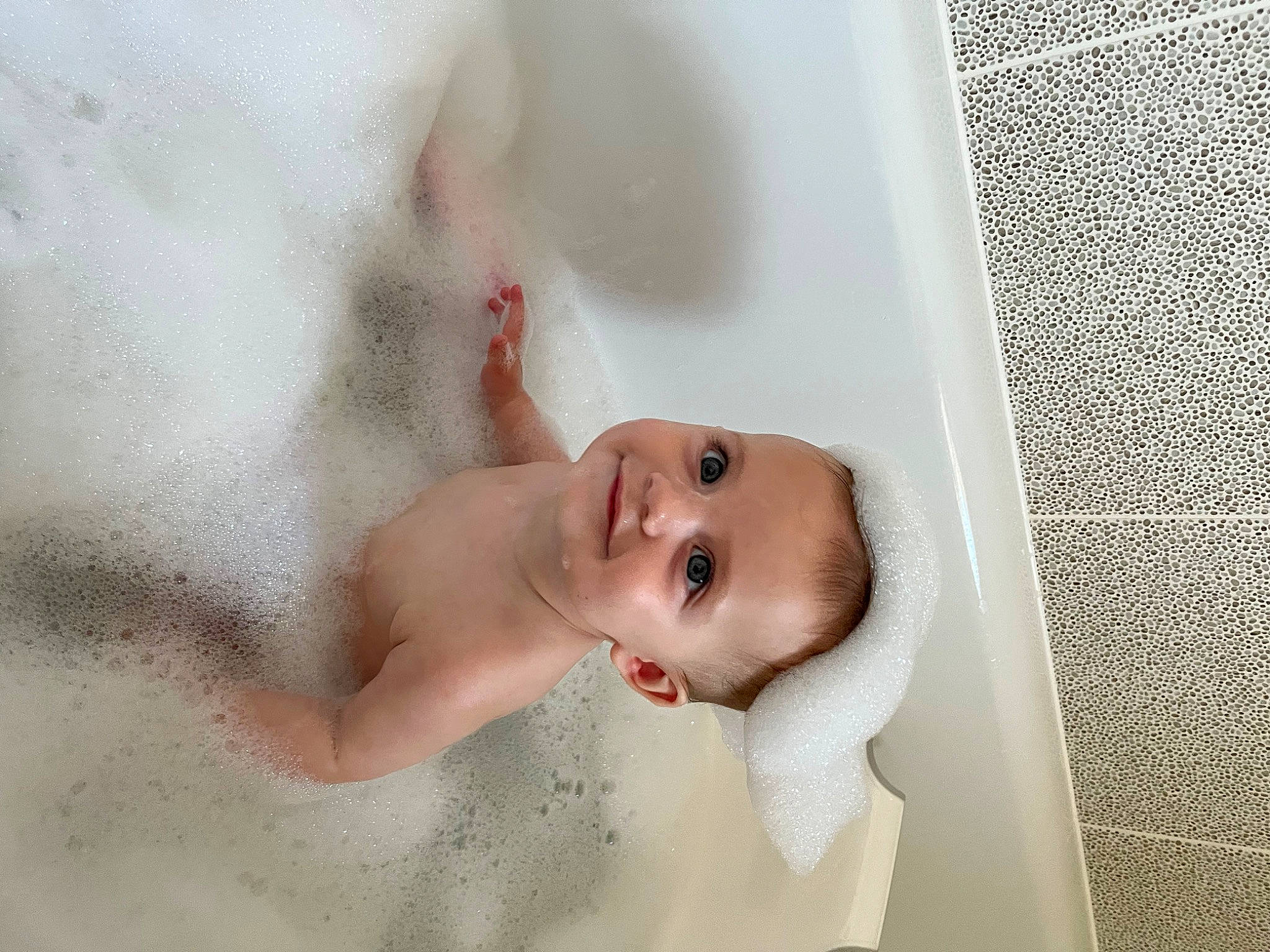 Lyra is registered to the contest to win money with this photo: art, baby, baby_products, baby_toddler_clothing, bathing, cheek, chest, comfort, eyebrow, eyelash, happy, joy, linens, lip, nose, person, plumbing_fixture, room, smile, stomach