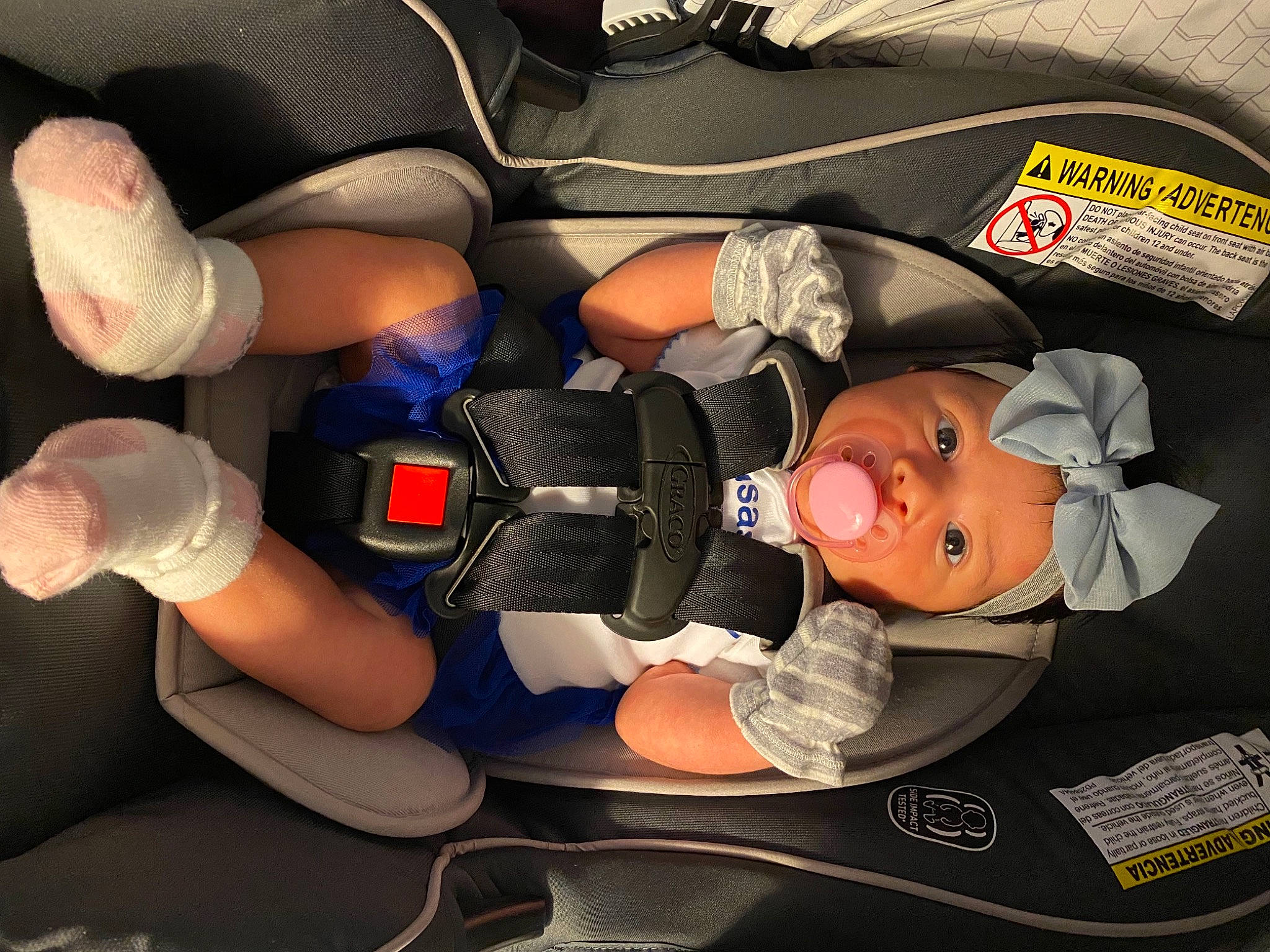Monica is registered to the contest to win money with this photo: arm, auto_part, automotive_design, baby, baby_carriage, baby_in_car_seat, baby_products, car_seat, child, comfort, finger, gesture, hand, headgear, headwear, mouth, nail, person, personal_protective_equipment, thumb