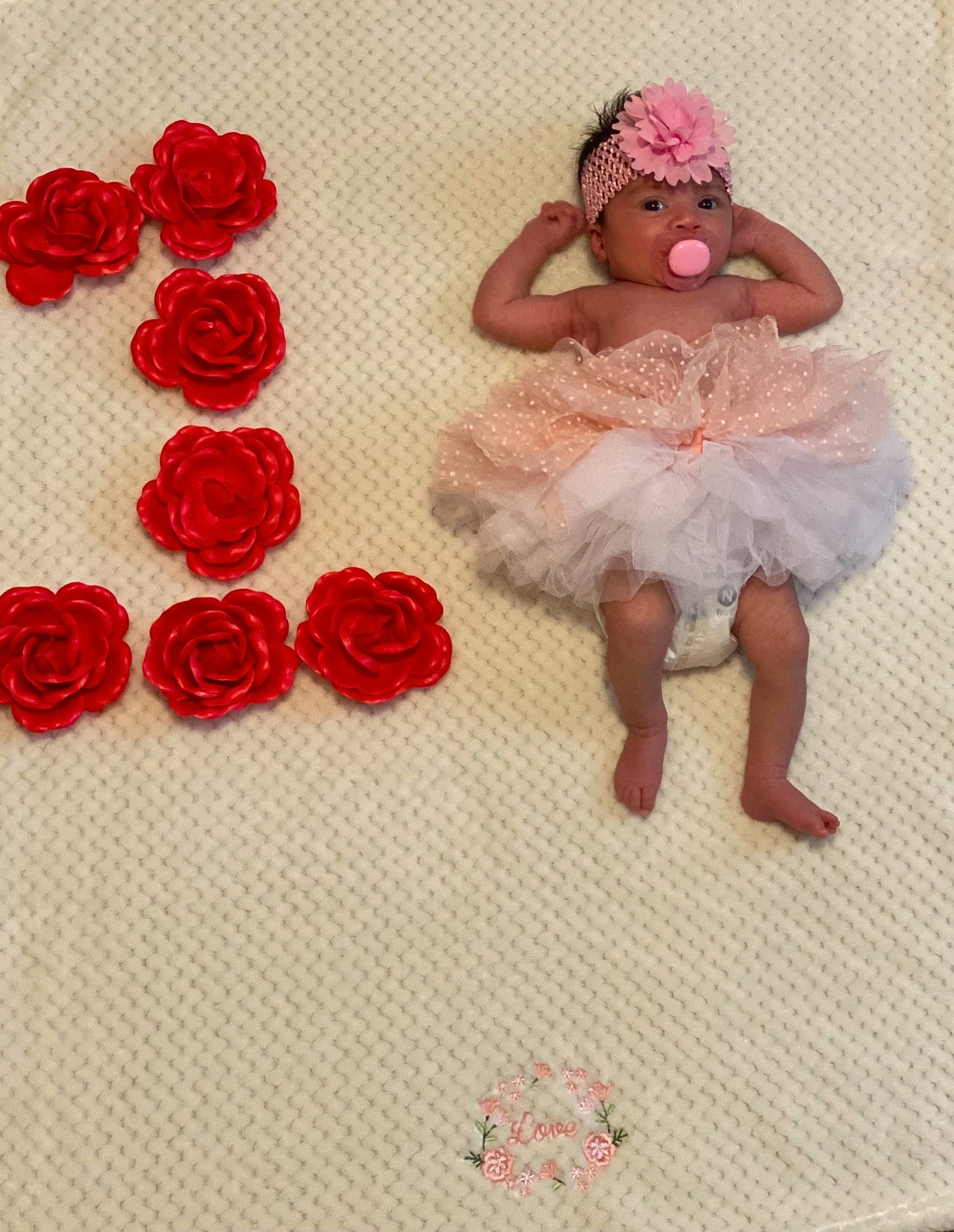 Monica is registered to the contest to win money with this photo: art, baby_toddler_clothing, bridal_accessory, clothing, dress, embellishment, event, facial_expression, fashion, flooring, flower, happy, headwear, pattern, peach, person, petal, pink, plant, red