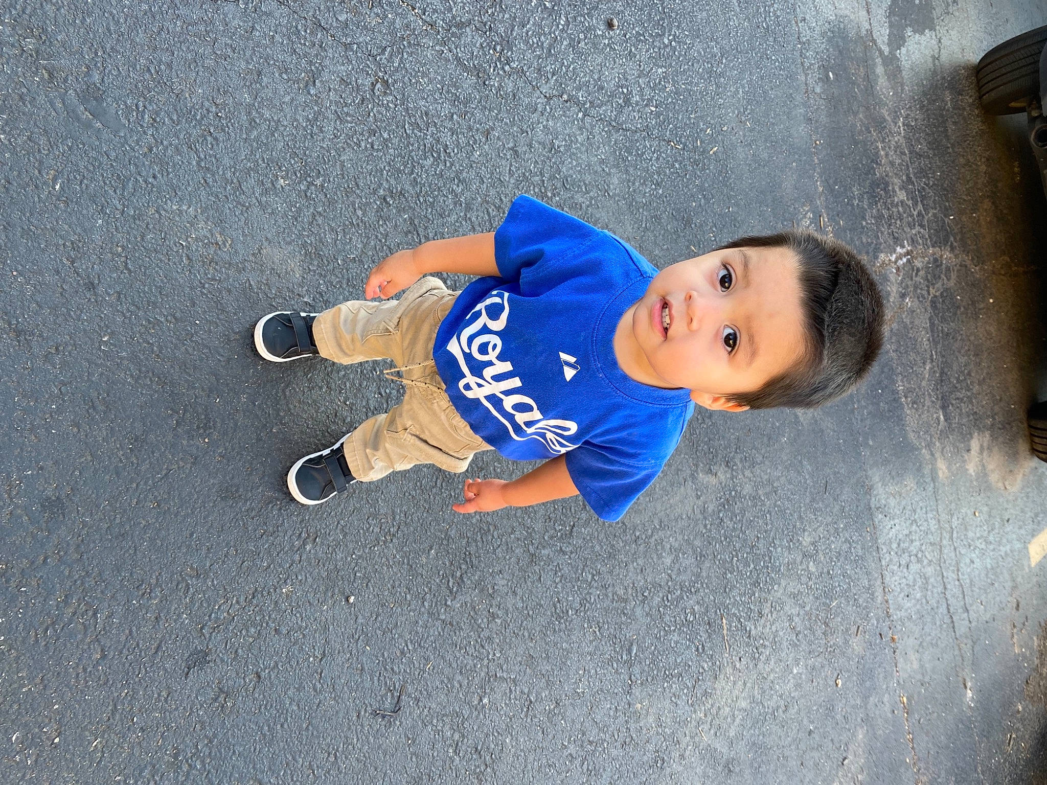 Bradley joined the competition — help win amazing prizes! asphalt, child, concrete, denim, electric_blue, flash_photography, flooring, fun, human_leg, person, road, road_surface, shadow, sidewalk, sitting, smile, sportswear, t_shirt, toddler, travel