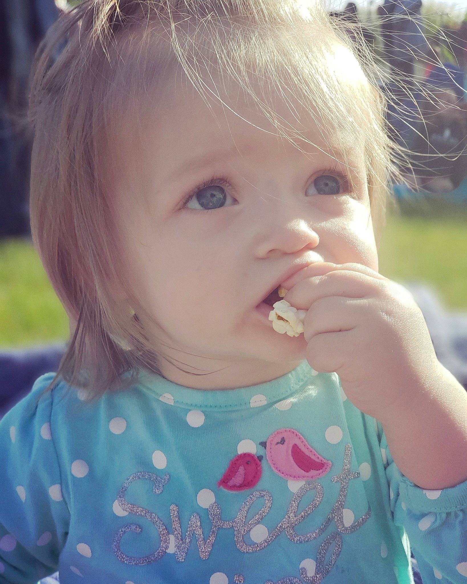 Lilith joined the competition — help win amazing prizes! brown_hair, cheek, child, eating, eye, face, grass, hair, lip, nose, person, skin, summer, toddler