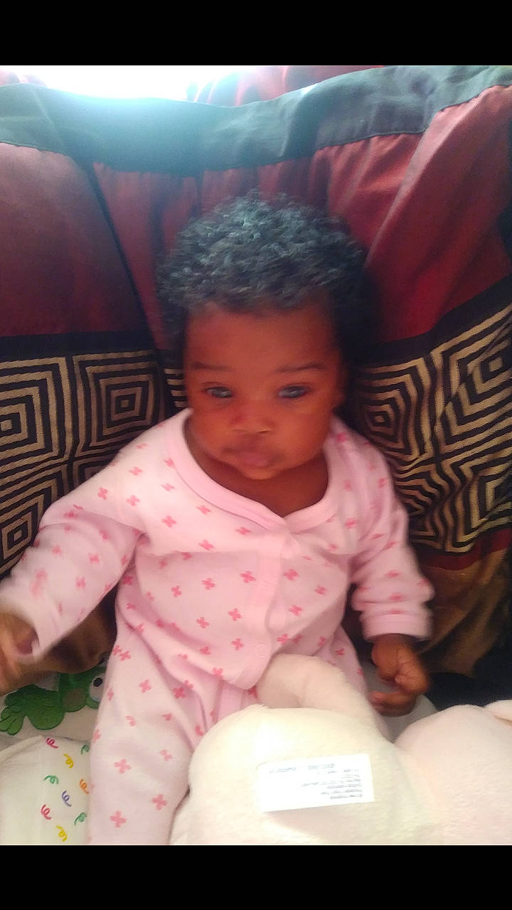 E'Mani is registered to the contest to win money with this photo: black_hair, cheek, child, day, eye, face, forehead, girl, hair, head, human_hair_color, infant, mouth, nose, person, pink, product, sitting, skin, toddler