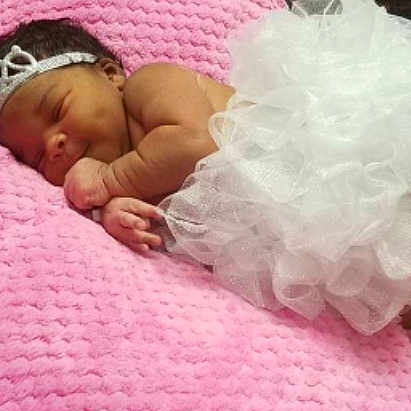 E'Mani joined the competition — help win amazing prizes! baby_products, bed, bedtime, child, finger, girl, hair_accessory, infant, petal, pink, product, skin, smile, textile, toddler