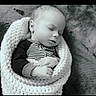 baby, sleeping, blanket, knitted, infant, peaceful, black_and_white, portrait, hands, cute, cozy, child, soft_texture, resting, wrapped, newborn, face, closeup, indoor, calm