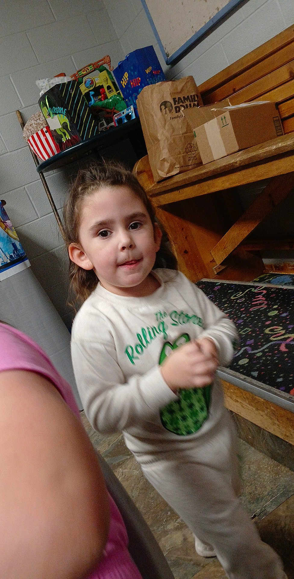 Harlee joined the competition — help win amazing prizes! child, indoor, person, sweatshirt, bench, bag, floor, wall, table, box, toy, carpet, face, hair, clothing, standing, expression, young, casual, portrait