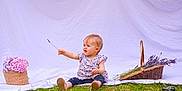 Luce a rejoint le concours — aidez-le/la à gagner de superbes lots ! baby, basket, child, clothing, curious_expression, cute, flower, grass, greenery, hydrangea, lavender, nature, outdoor, photography, plant, portrait, sitting, summer, toddler, white_backdrop