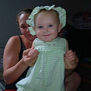 Journey is registered to the contest to win money with this photo: baby, blouse, bodypart, bonnet, cap, clothing, costume, dress, face, finger, happy, hat, head, laughing, person, photography, portrait, sitting, smile, swimwear