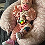 Catalina is registered to the contest to win money with this photo: baby, pink, pacifier, headband, bow, cushion, leaf_pattern, sneakers, mittens, infant, clothing, sitting, indoor, cute, child, person, fashion, comfortable, soft, portrait