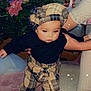 Marbella participe au concours pour gagner de l'argent avec cette photo : baby, child, plaid, hat, black_sweater, christmas_tree, ornaments, carpet, pink_carpet, indoor, person, hand, socks, feet, holiday, festive, decorations, sparkles, supporting_hand, cozy