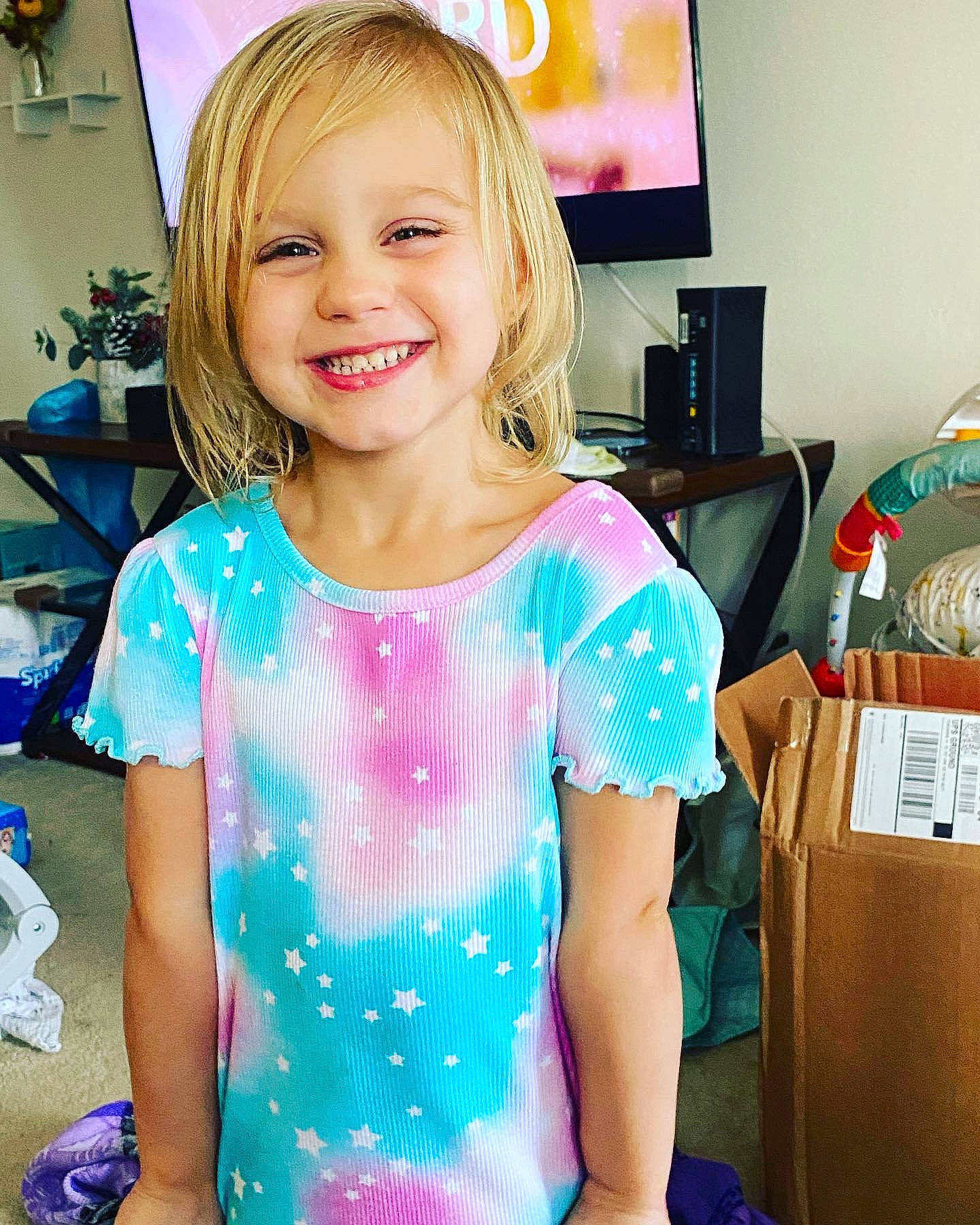 Olivia is registered to the contest to win money with this photo: baby_toddler_clothing, blond, electric_blue, event, eyelash, fun, hair, hairstyle, happy, joy, leisure, magenta, person, picture_frame, pink, shoulder, sitting, sleeve, smile, standing