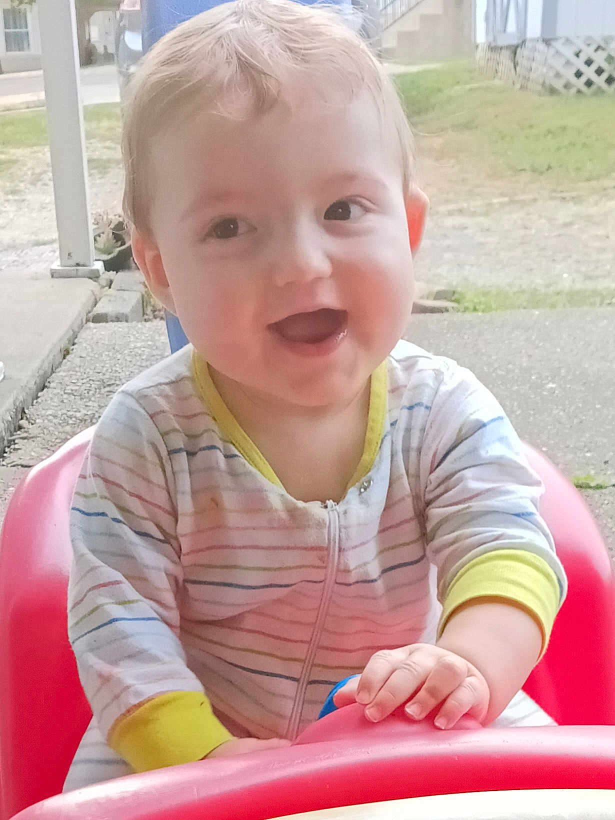 Trenton joined the competition — help win amazing prizes! baby, child, smiling, outdoor, seat, plastic_seat, onesie, striped_clothing, happy, face, hand, grass, concrete, porch, young_child, playful, person, casual, daylight, cute