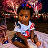 baby, blanket, blue, bottle, celebration, child, festival, fireworks, flag, grass, happy, night, outdoor, party, patriotic, people, red, ribbons, toddler, white