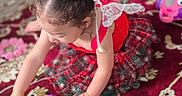 Eliana is registered to the contest to win money with this photo: child, toddler, girl, portrait, playtime, toy, shape_sorter, colorful, dress, hair_buns, brown_hair, sitting, indoors, rug, patterned_carpet, focused, playing, children_toy, home, safe