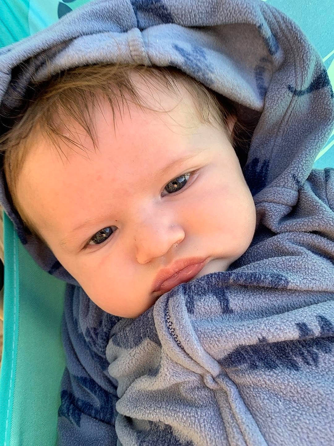 Bo is registered to the contest to win money with this photo: azure, baby, baby_toddler_clothing, cap, cheek, child, chin, close_up, eyebrow, eyelash, hat, headgear, iris, lip, nose, outerwear, person, plant, skin, sleeve